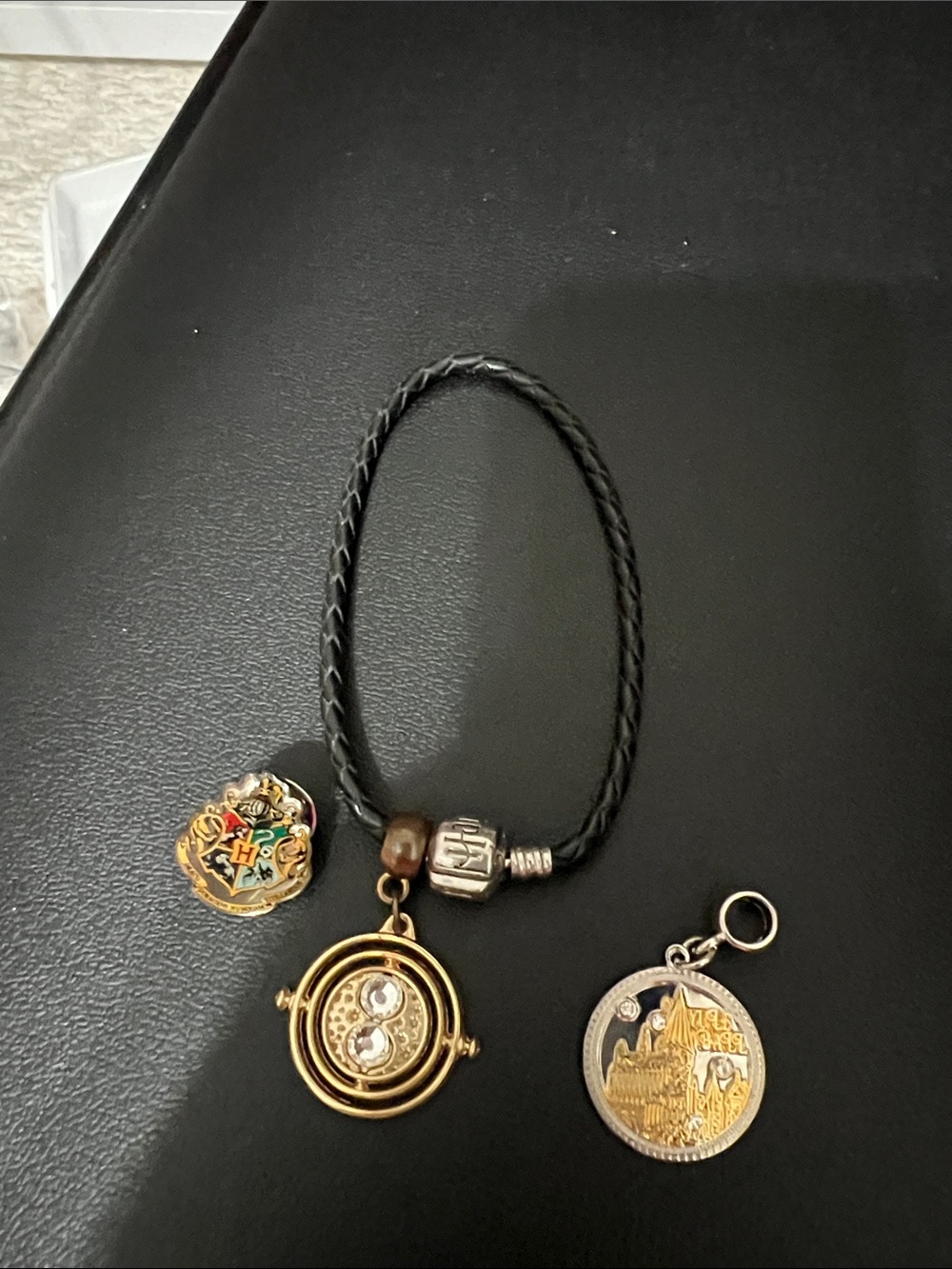 Harry Potter Braided Bracelet with Gold Time-Turner and Hogwarts Charms and pin